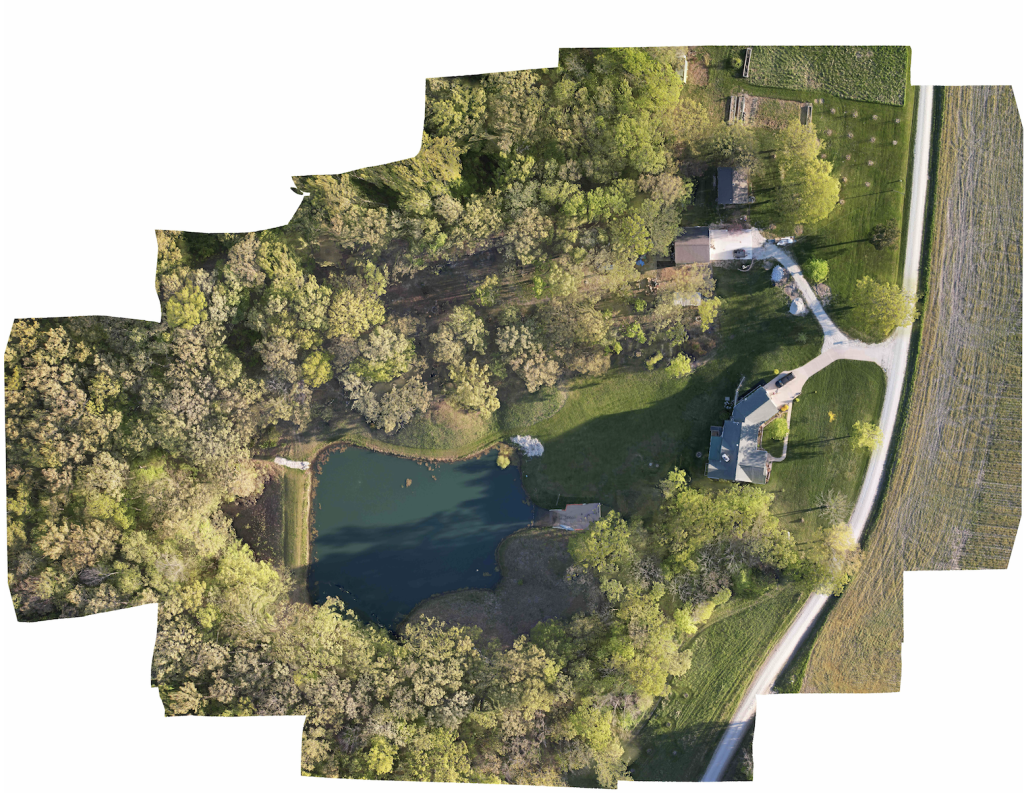 Drone aerial map showing a pond, woodland, buildings, and a rural road